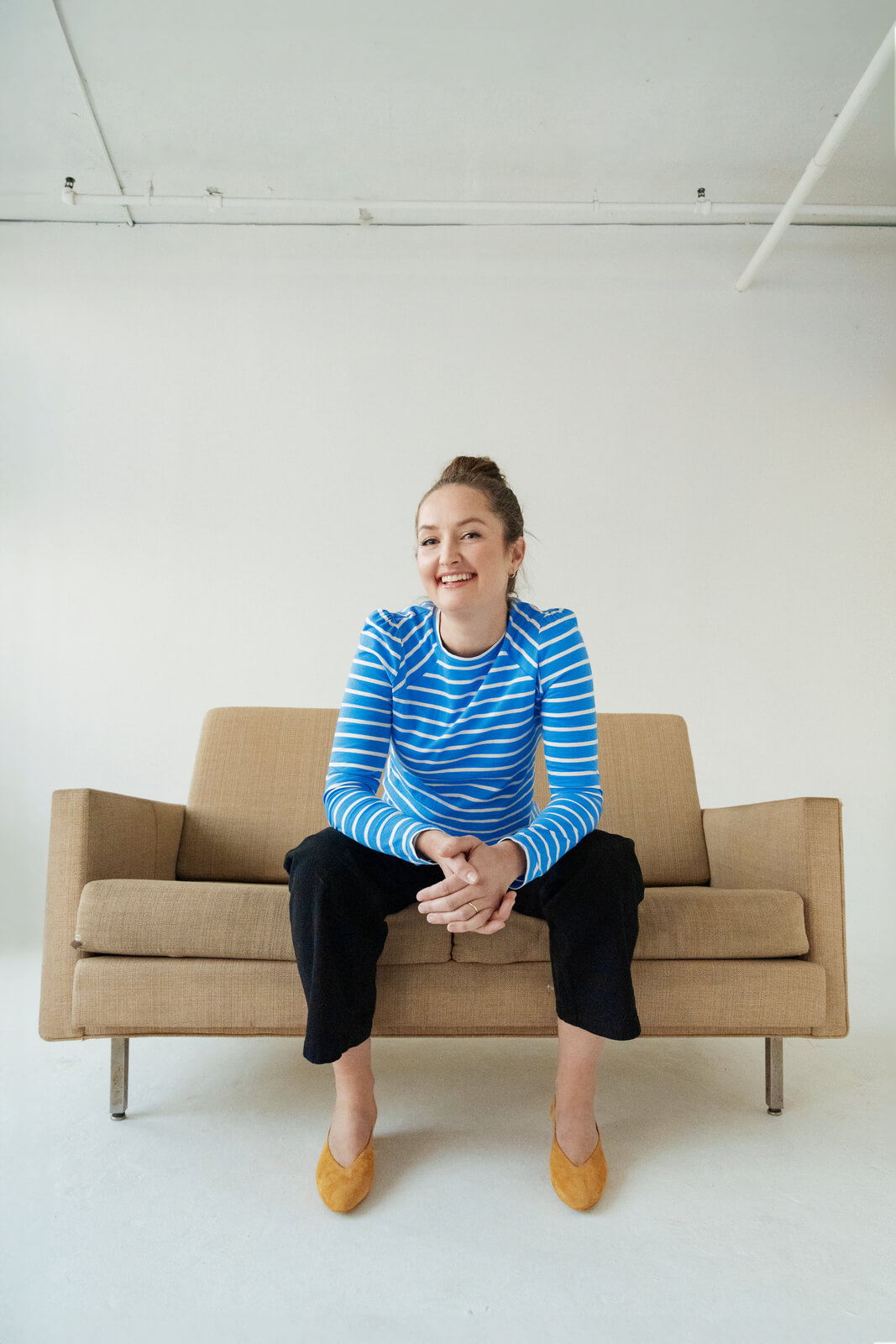 Cecelia Mandryk sitting on couch smiling